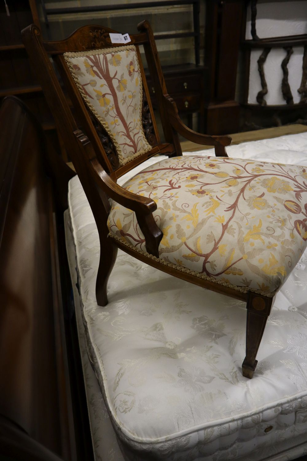 A late Victorian marquetry inlaid rosewood low seat chair
